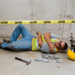 Image of a man lying on the ground after an injury on the job.